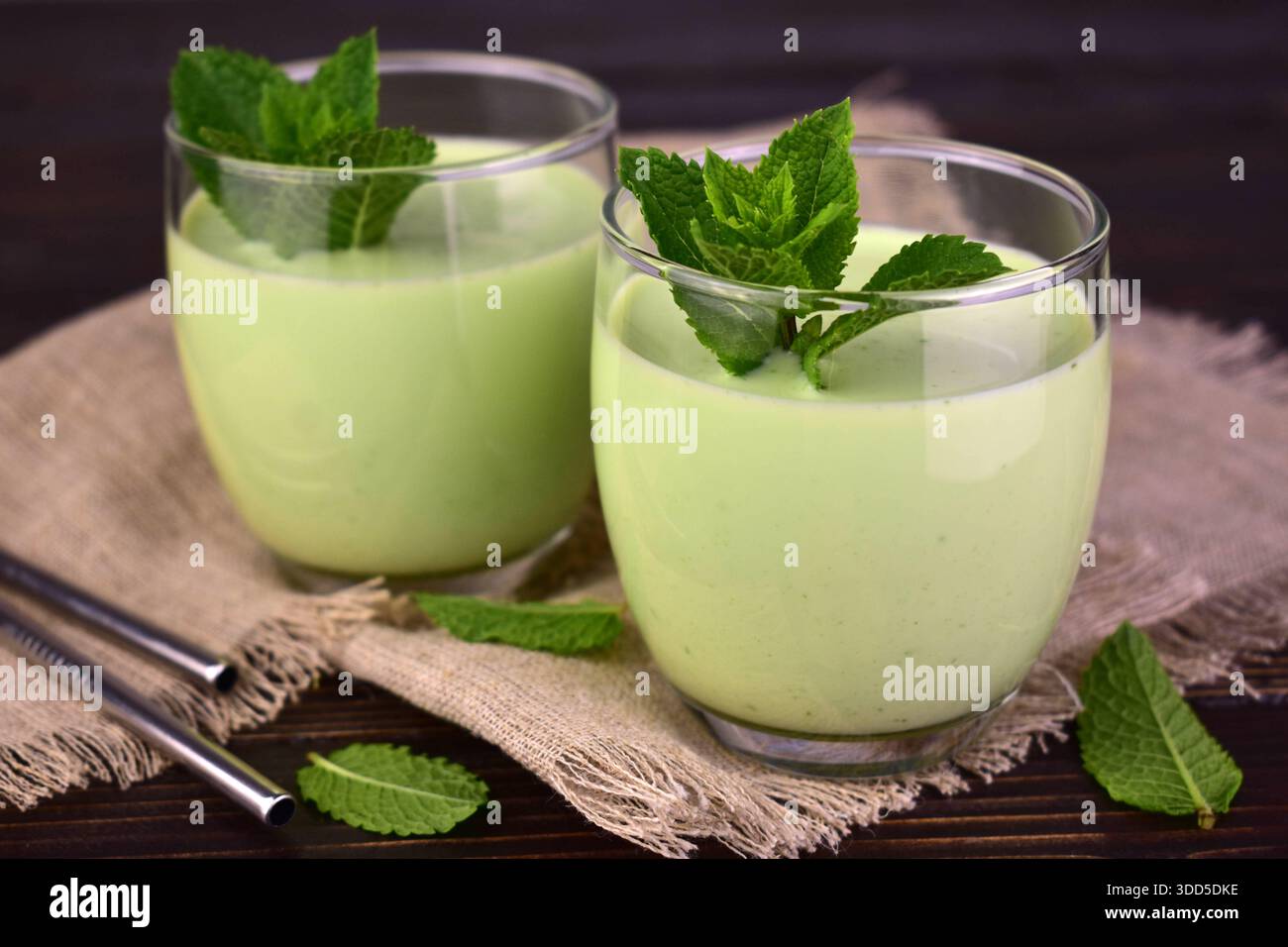 Mint milkshake on a dark wooden table. Foreground. Stock Photo
