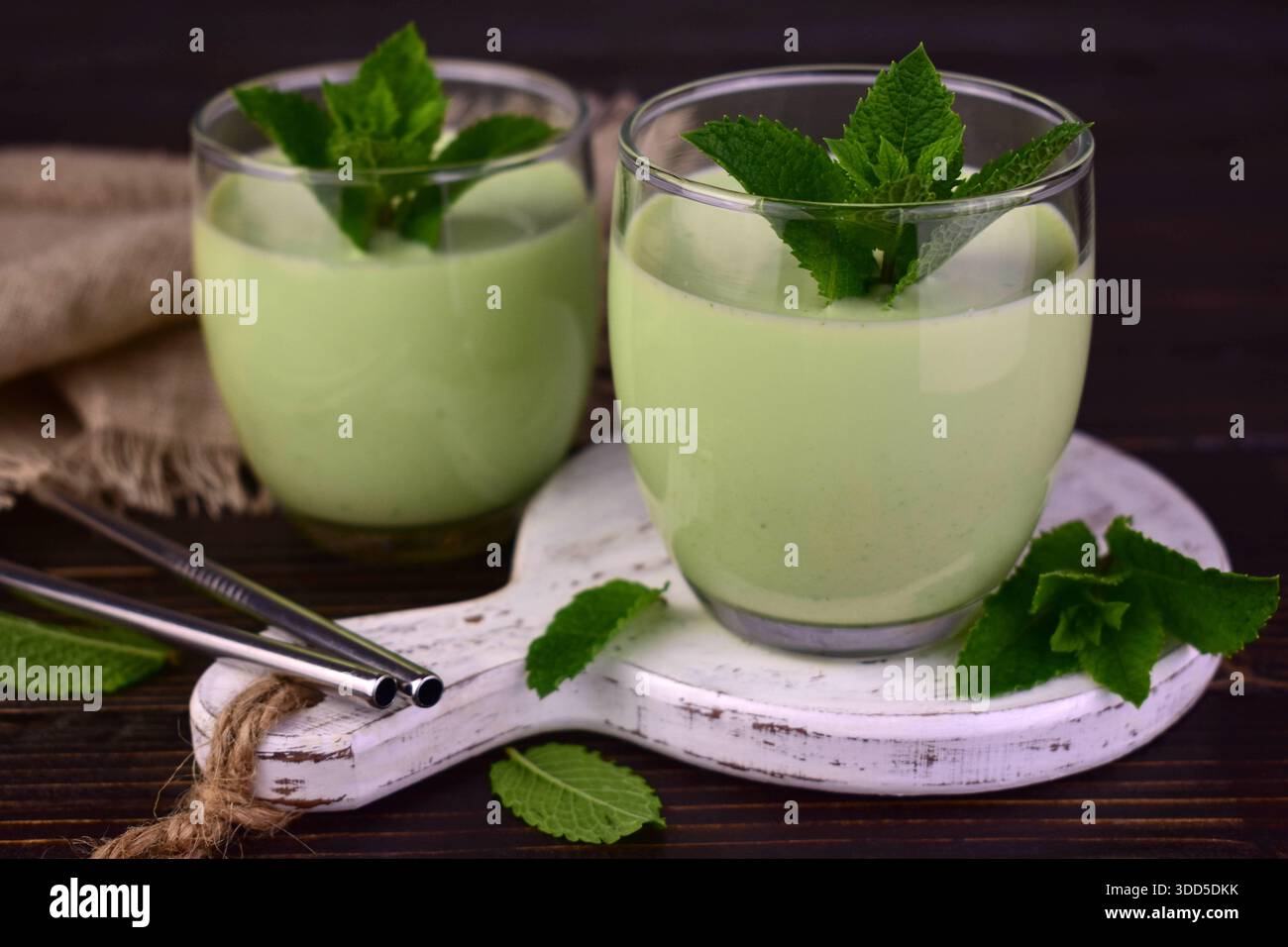 Mint milkshake on a dark wooden table. Foreground. Stock Photo