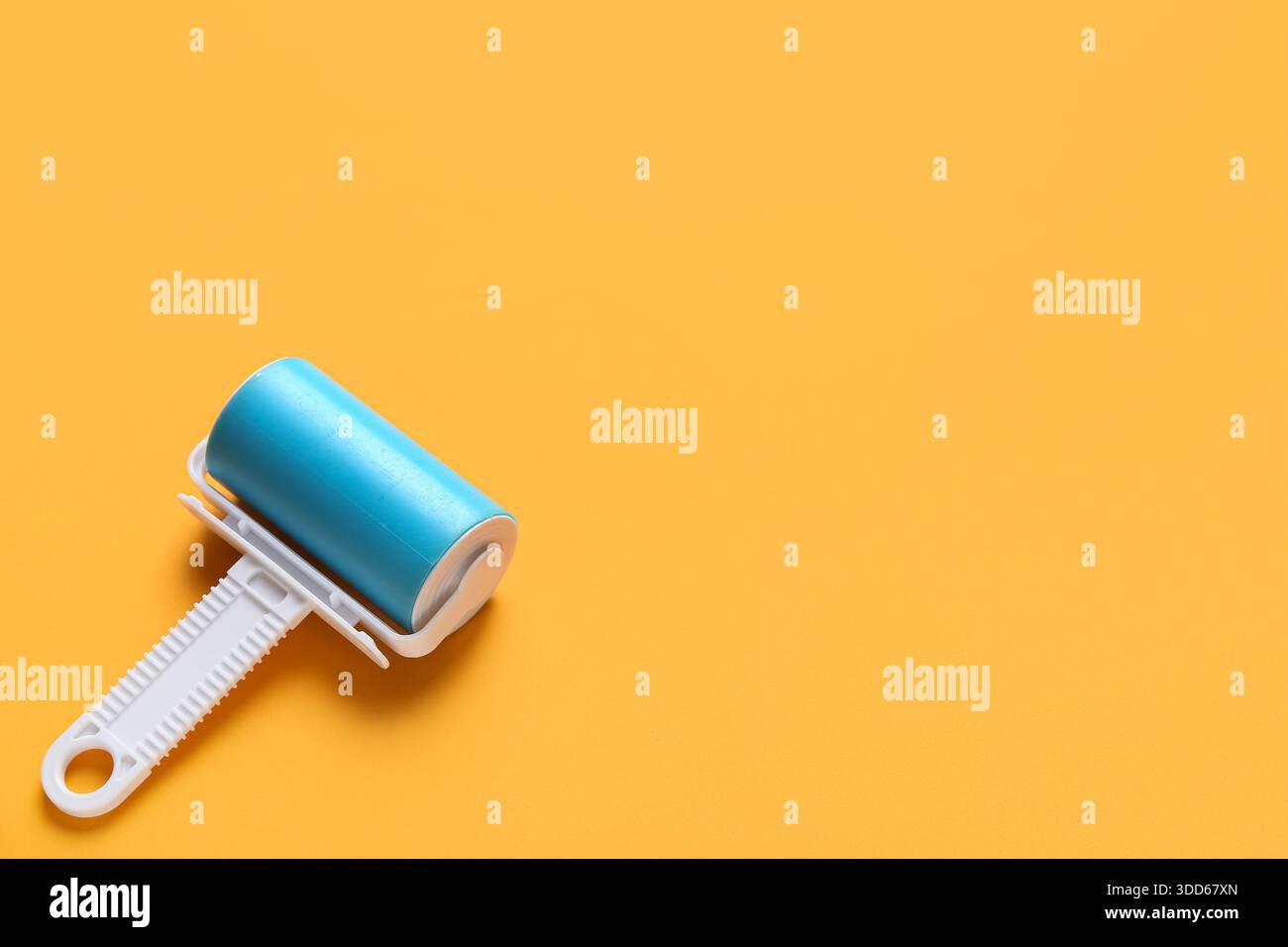 Lint roller on orange background Stock Photo