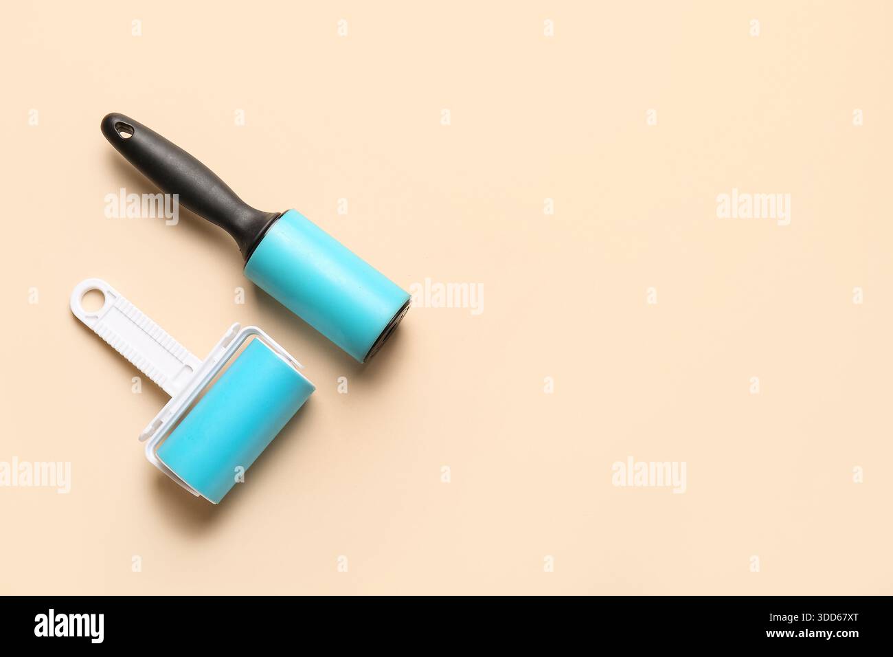 Different lint rollers on beige background Stock Photo