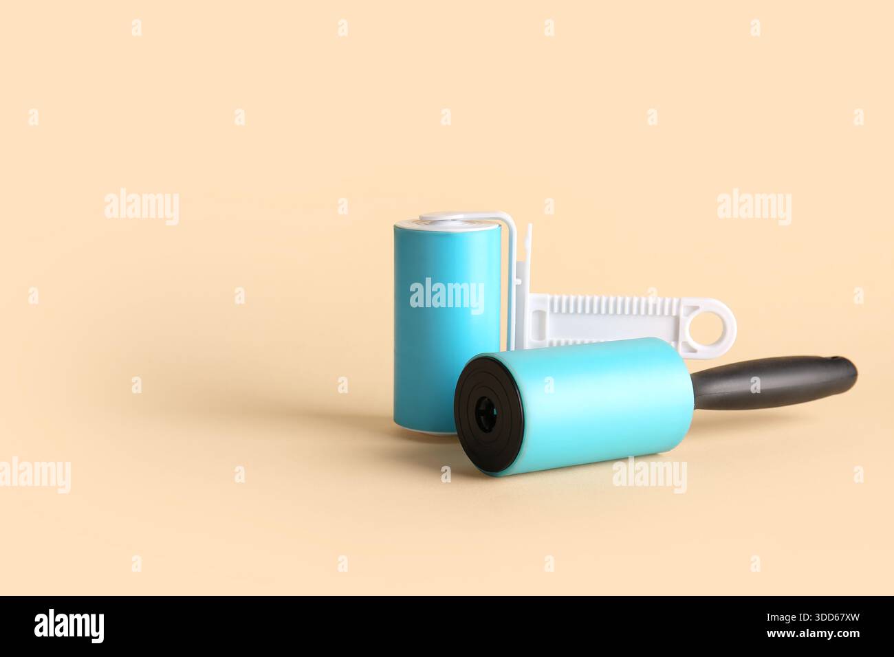 Different lint rollers on beige background Stock Photo