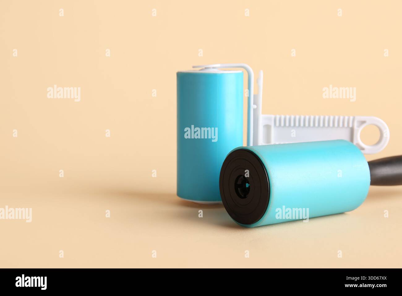 Different lint rollers on beige background Stock Photo