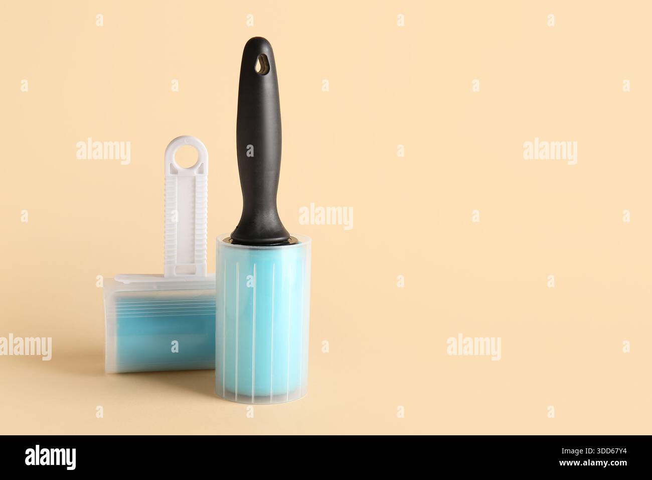 Different lint rollers on beige background Stock Photo