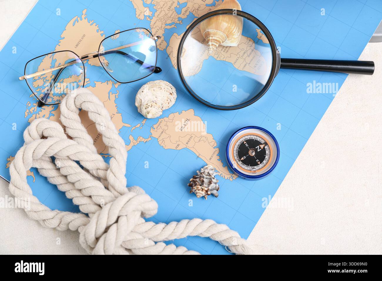 Composition with modern compass, magnifier and world map on white background Stock Photo