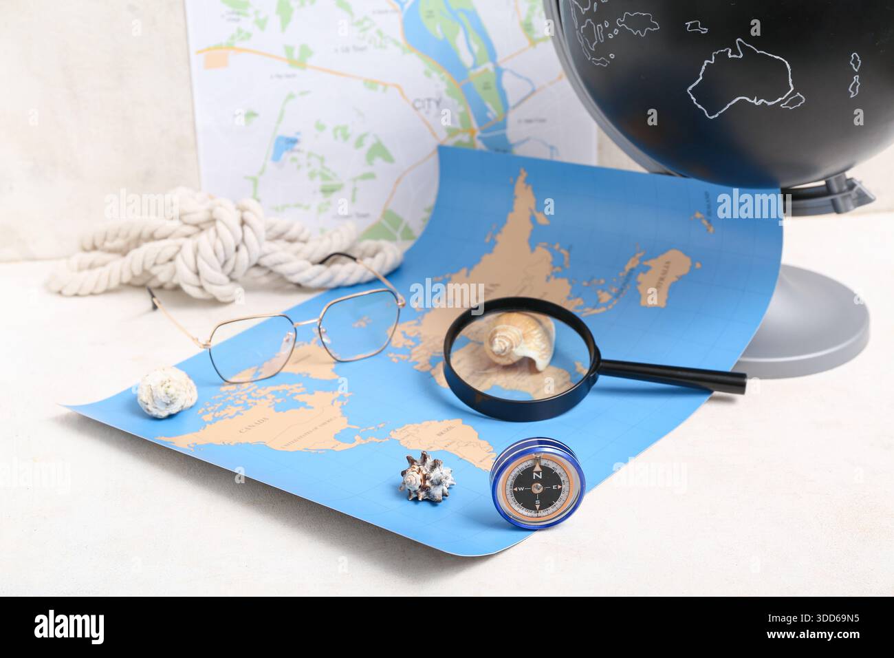 Composition with modern compass, magnifier and world map on white background Stock Photo