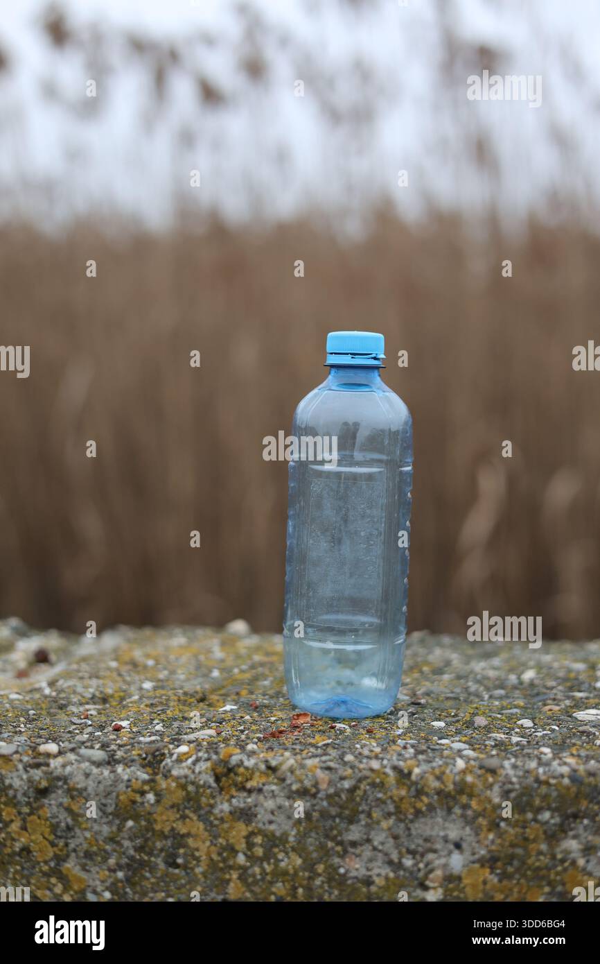 Empty plastic bottle flagon thrown into nature Stock Photo