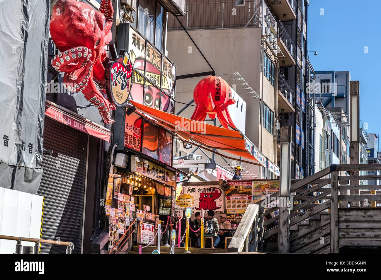 Takoyaki restaurant in Osaka with large red octopus decoration at the entrance. Red squid decorations adorn a takoyaki restaurant in Osaka, Osaka Prefecture, Japan Stock Photo