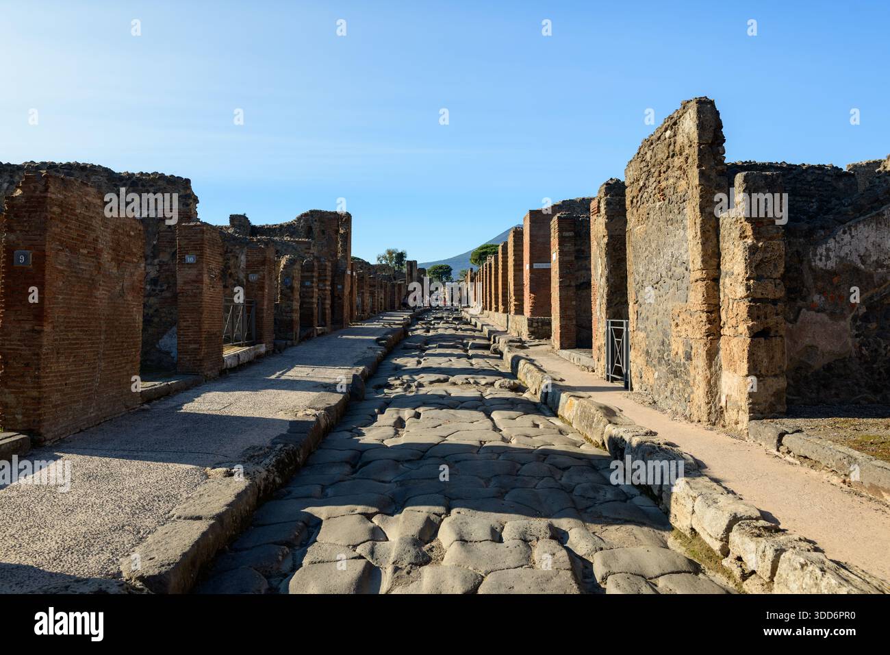 Expansive ancient Roman street lined with weathered brick columns and ...