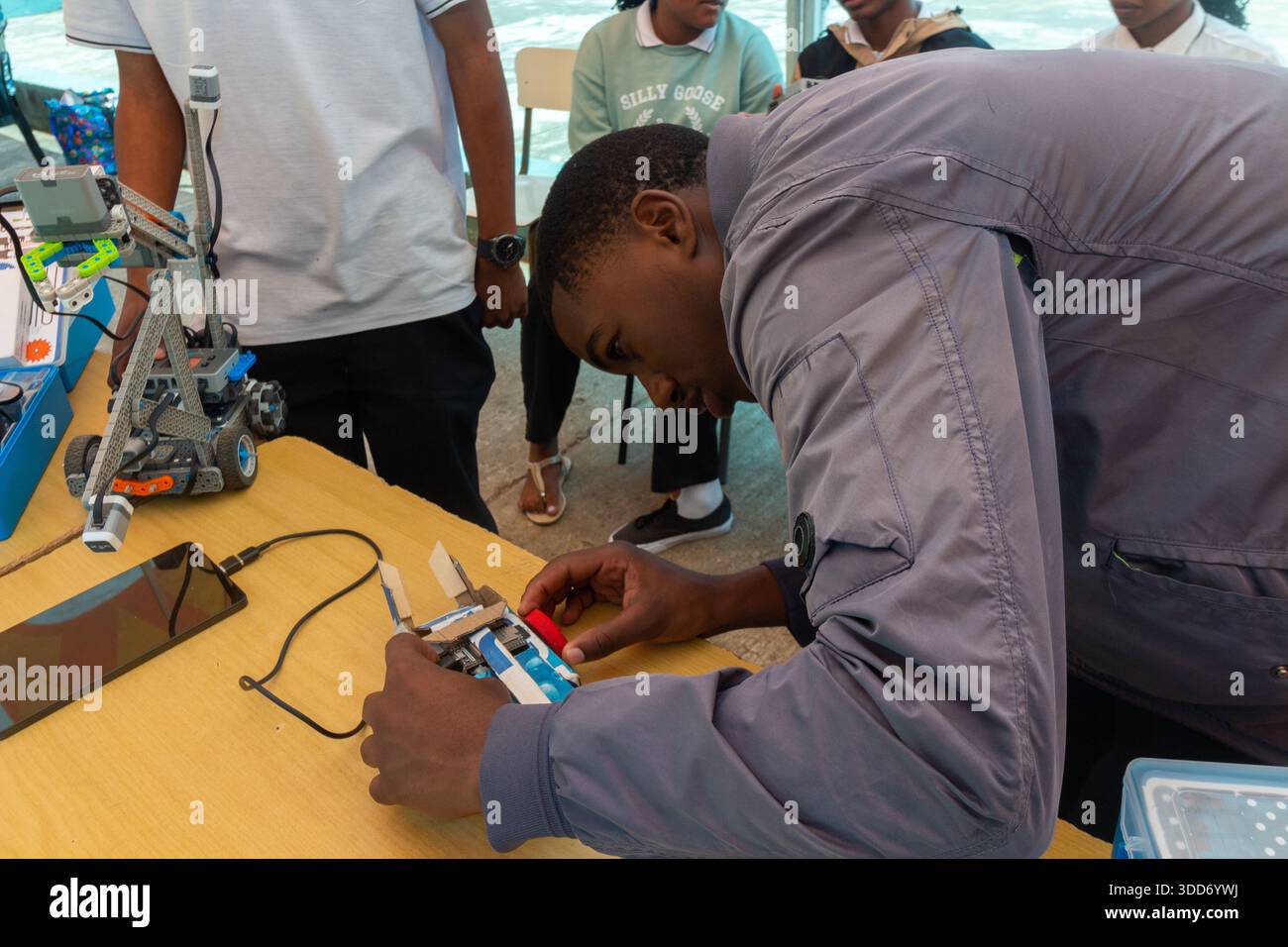 Students assemble and test an educational robot using electronic parts Stock Photo