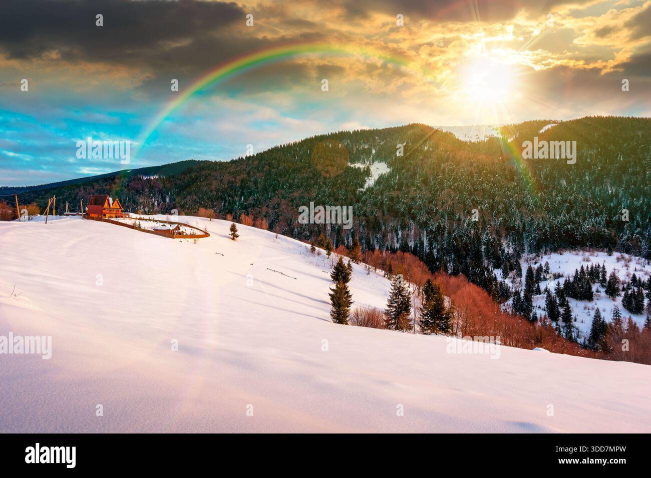 beautiful winter landscape with snow covered hills at sunset. serene rural scene in mountains in evening light. rolling countryside area. timeless chr Stock Photo