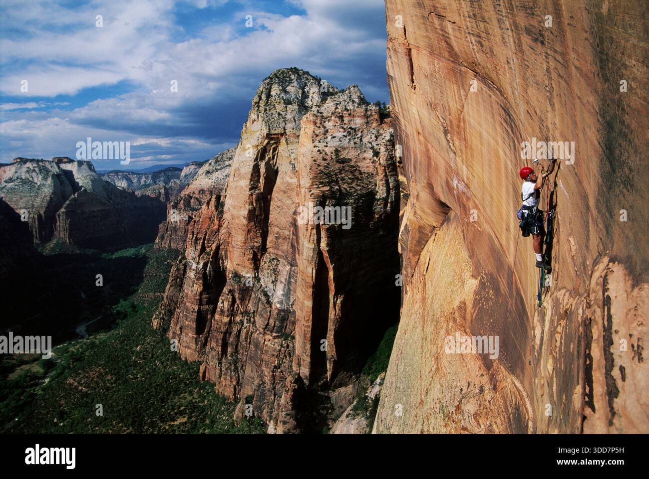 Rock climber using direct aid to scale an overhanging sandstone wall, Utah, USA. Stock Photo