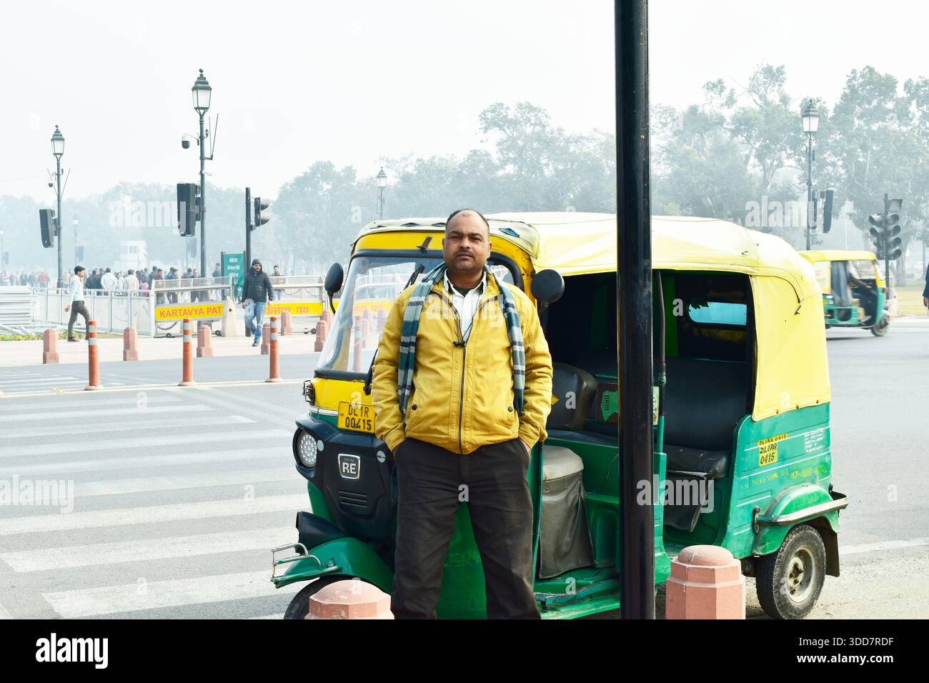 New Delhi, India 29 December 2025:- auto driver standing next to green ...
