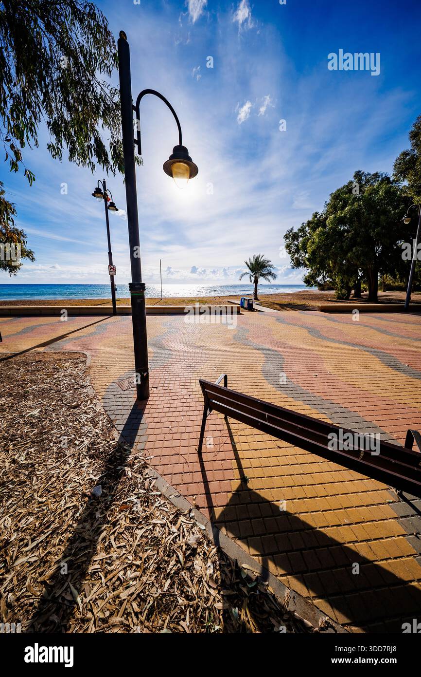 Sunset Stroll on Patterned Boardwalk Stock Photo