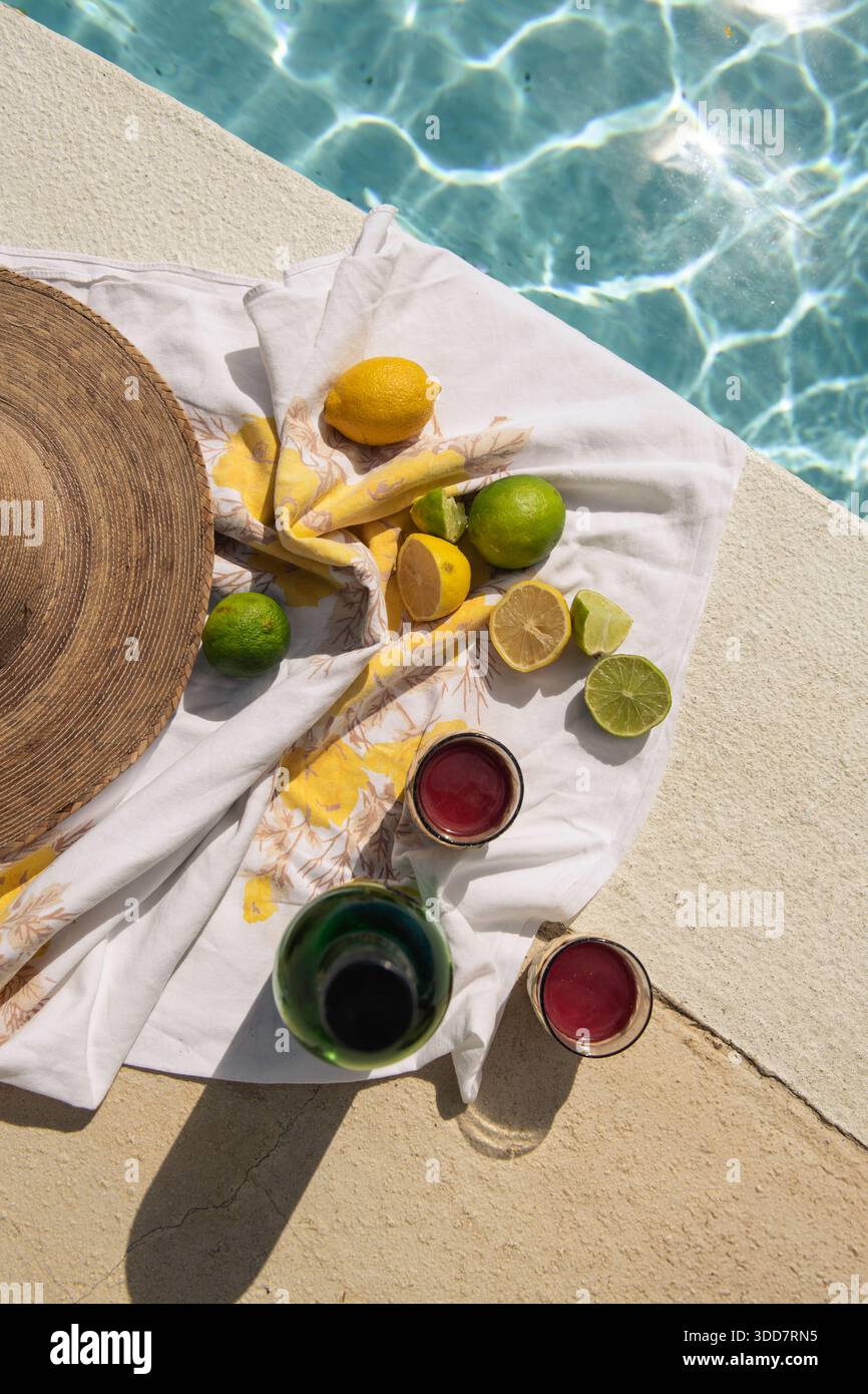 citrus and drinks next to pool on sunny day Stock Photo