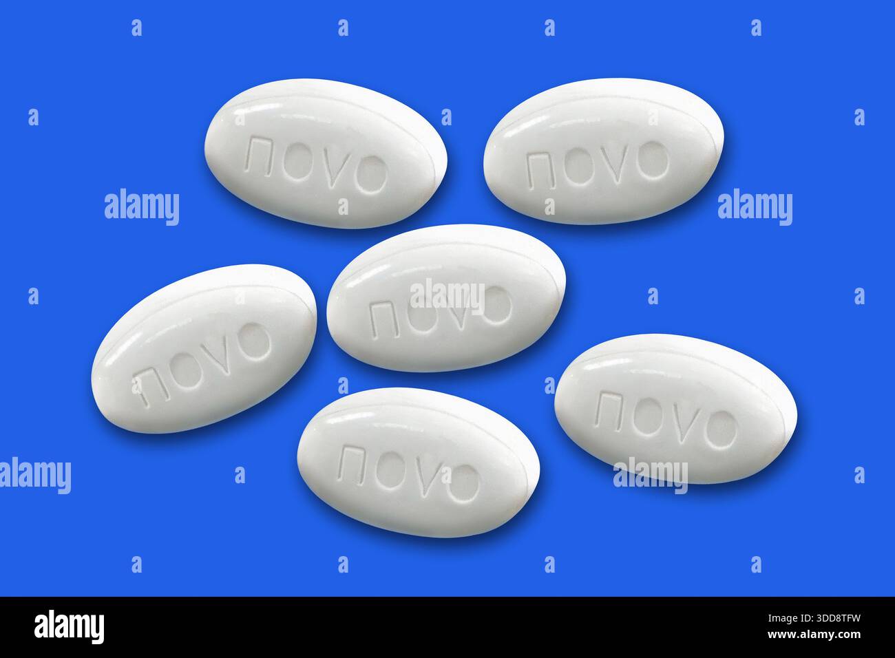 Pills from Novo Nordisk pharmaceutical company lies on a blue background. Copenhagen, Denmark - December 23, 2025. Stock Photo