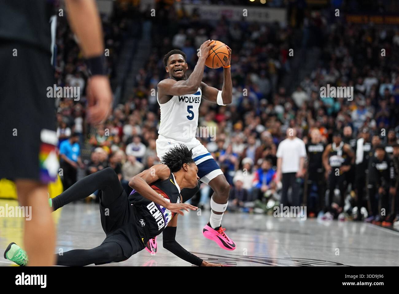 Minnesota Timberwolves guard Anthony Edwards (5) collects a loose ball as  Denver Nuggets guard Peyton Watson (
