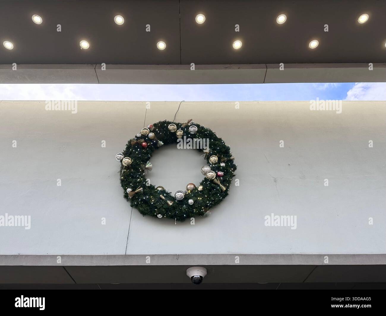 Christmas Wreath Displayed on Modern Building Exterior - Smartphone Captured Stock Image