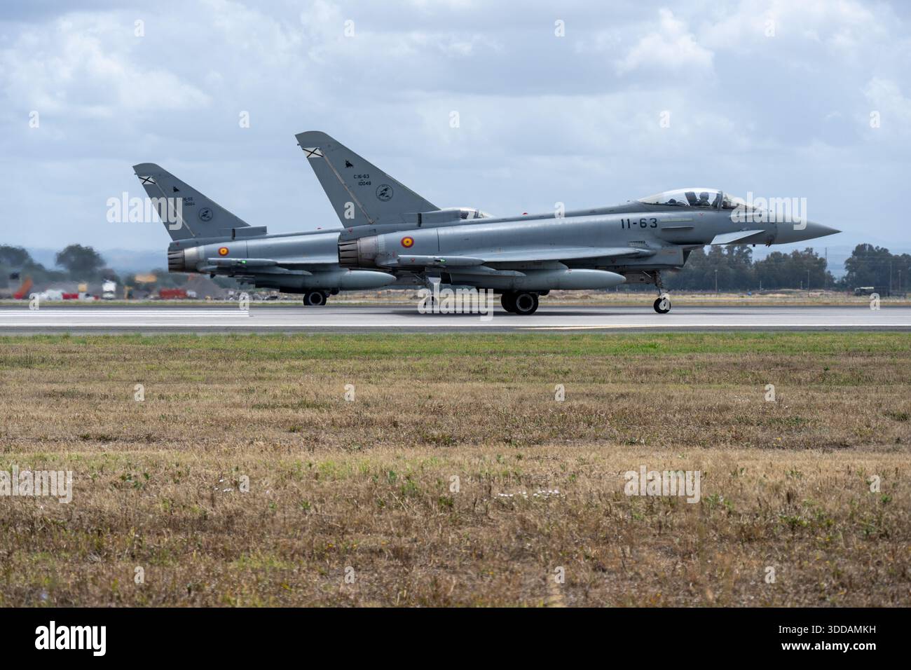 Moron, Spain - 3 May 23: Two Spanish Air Force Eurofigher Typhoon fighter jets on an airfield ready for takeoff Stock Photo