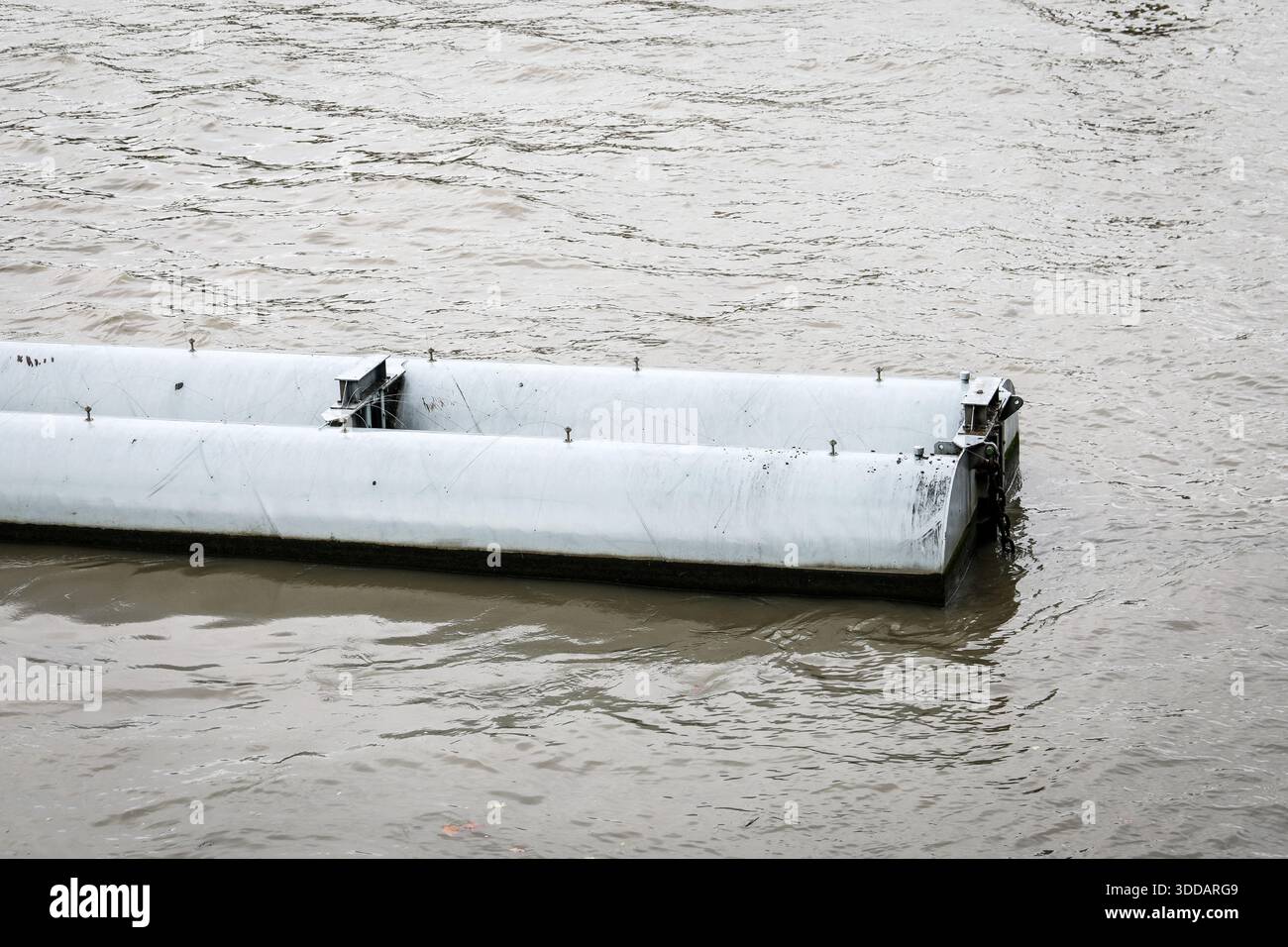 Floating River Barrier Concept Shown As Modular Water Control Structure On Flowing River Surface Stock Photo