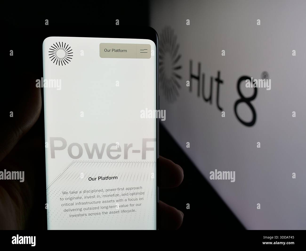 Stuttgart, Germany - 12-17-2025: Person holding smartphone with web page of  US crypto mining company Hut 8 Corp. on screen in front of logo Stock Photo  - Alamy