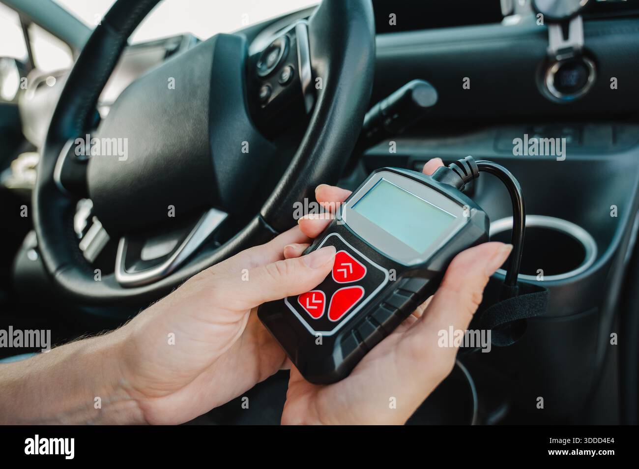 Woman using OBD2 diagnostic scanner.  Stock Photo