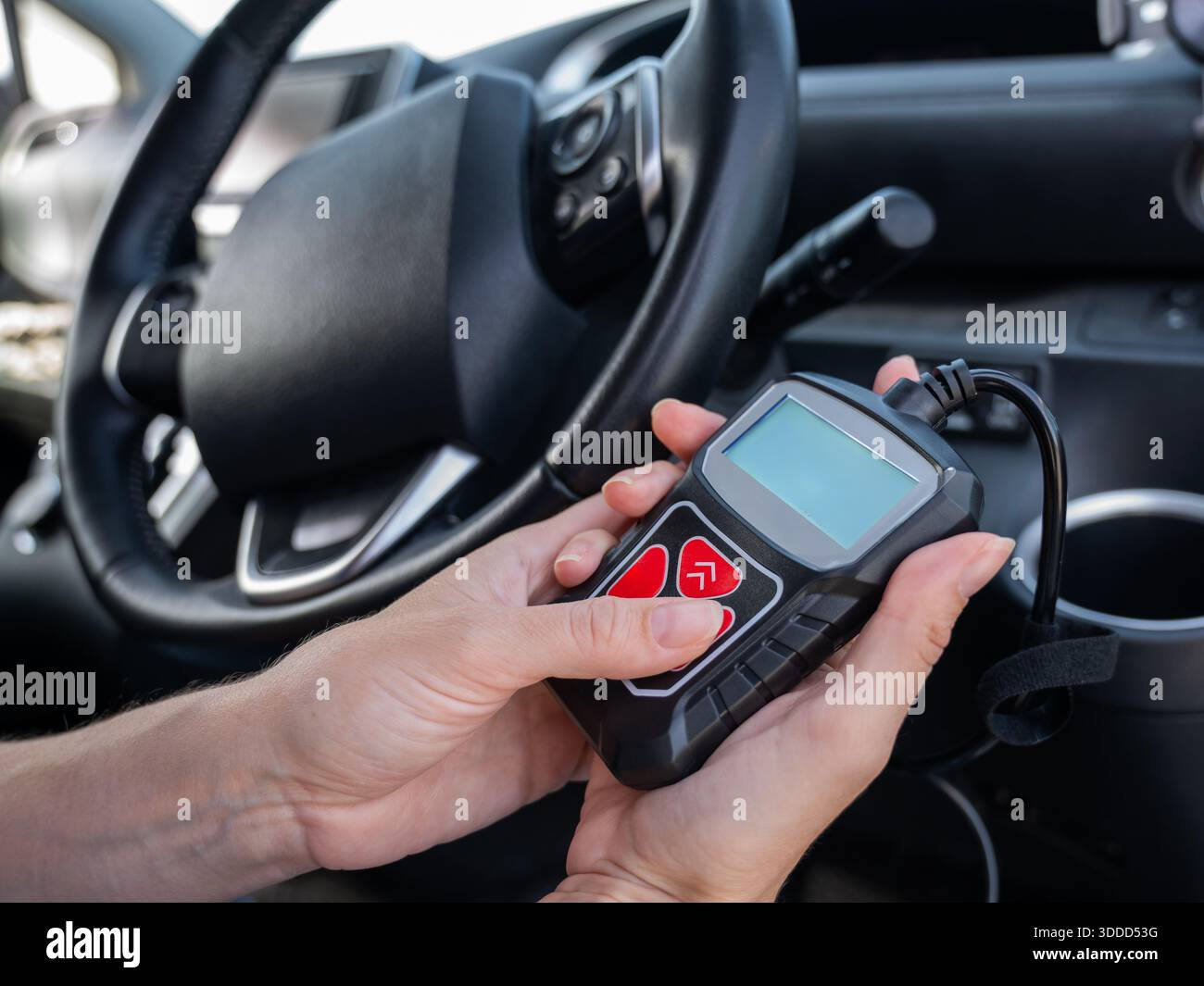 Woman using OBD2 diagnostic scanner.  Stock Photo