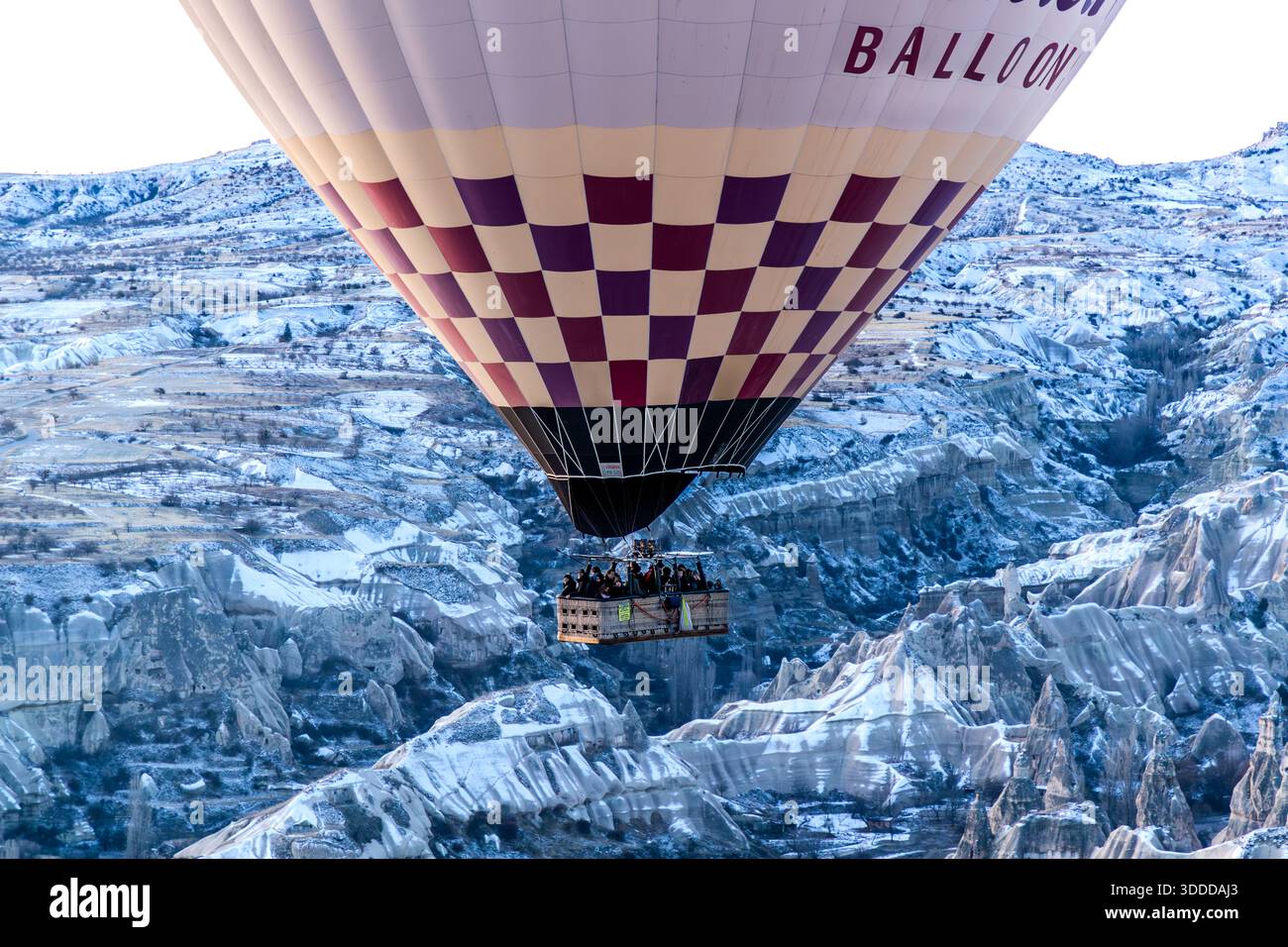 Balloon ride in the bitter cold over the snow-covered landscape of Göreme, Central Anatolia Region, Turkey Stock Photo