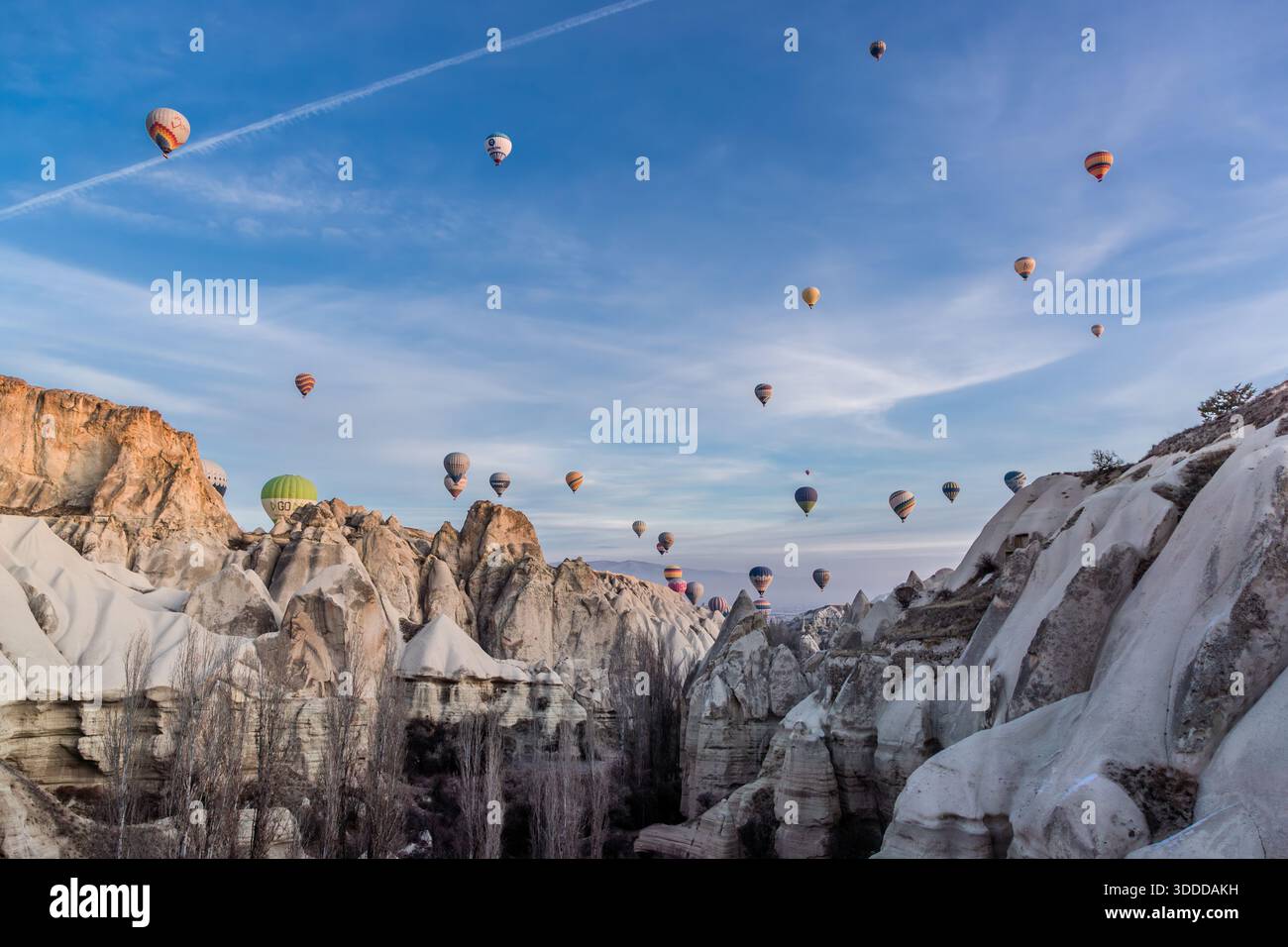 Hot air balloons rise above the rock formations of Göreme, Central Anatolia Region, Turkey. Tuff stone landscape and fairy chimneys Stock Photo
