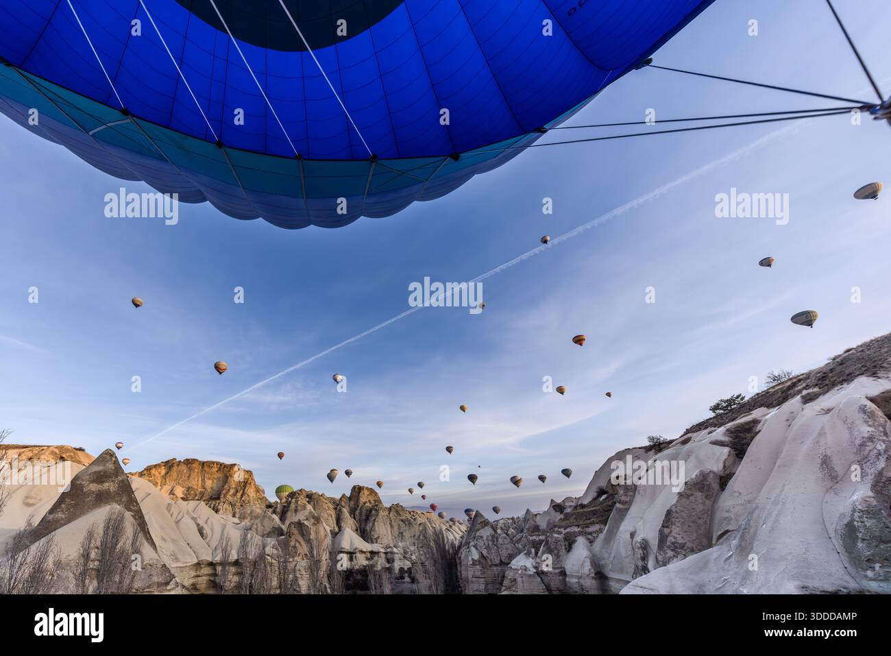 Hot air balloons rise above the rock formations of Göreme, Central Anatolia Region, Turkey Stock Photo