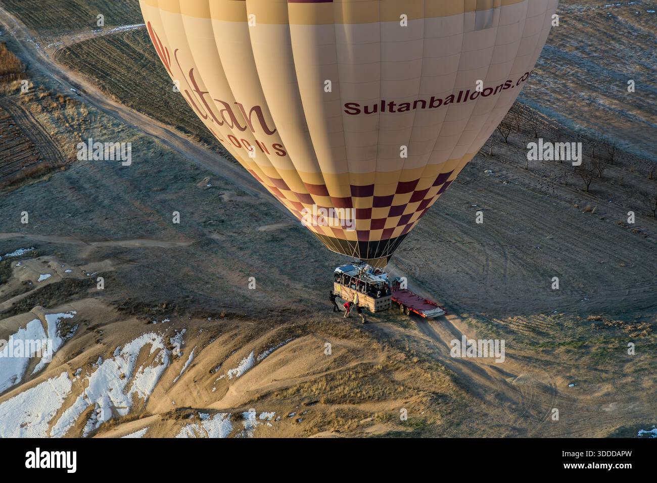 Sultanballoons hot air balloon lands near Göreme, Central Anatolia Region, Turkey Stock Photo