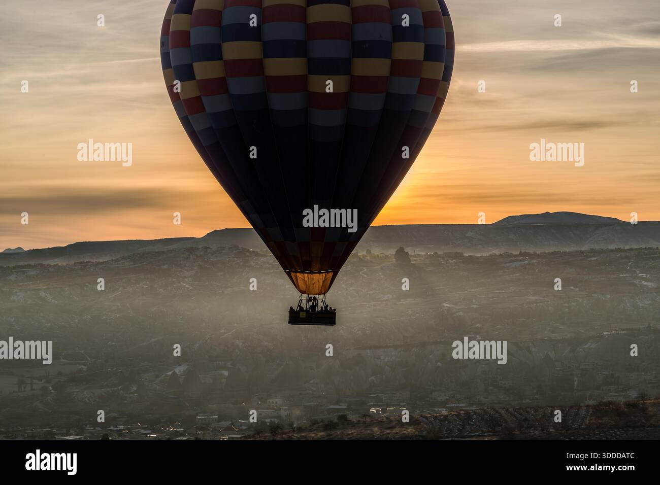 Hot air balloon with passengers flies over Göreme, Central Anatolia Region, Turkey Stock Photo