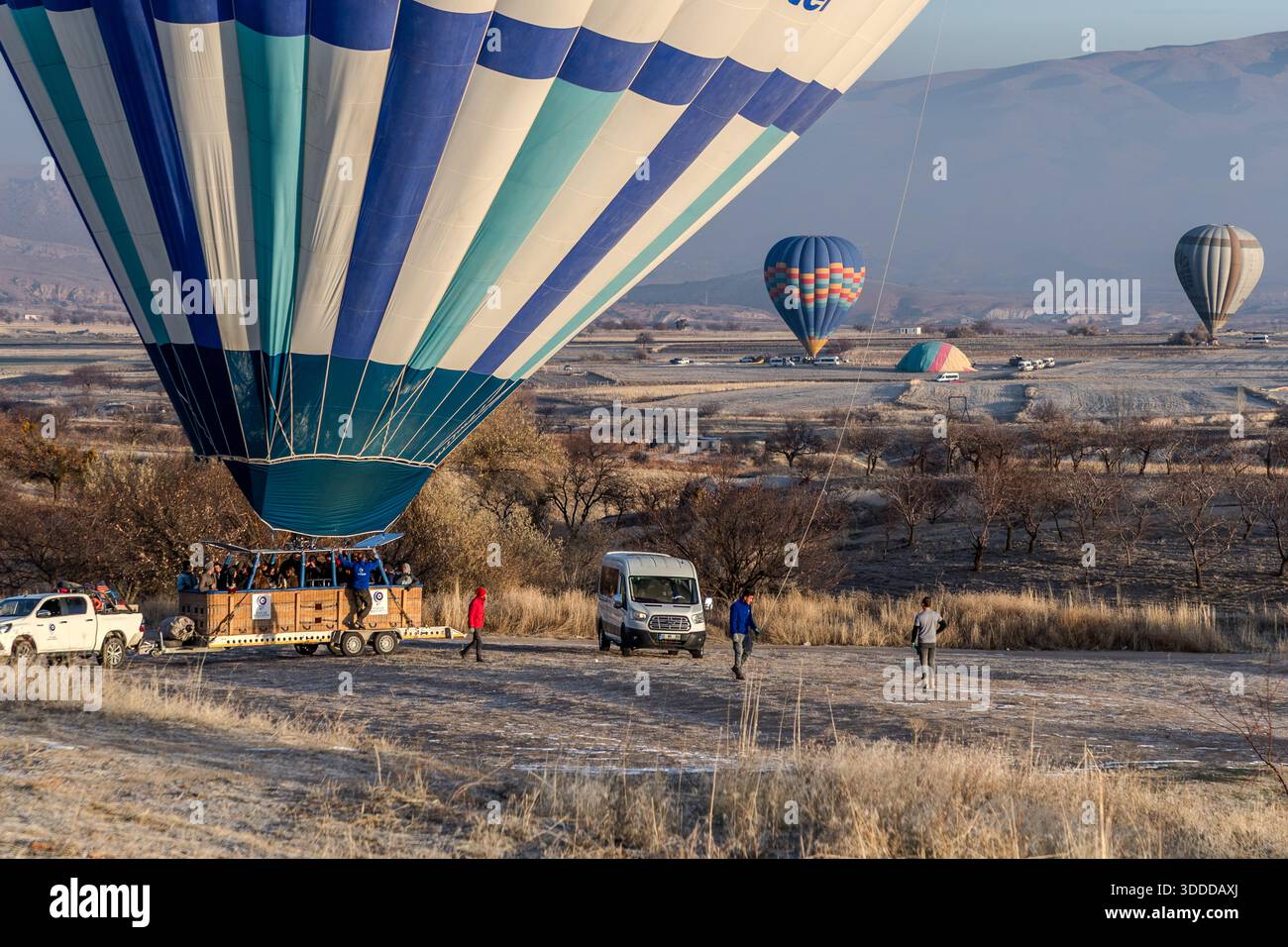 Hot air balloons land at sunrise in Göreme, Central Anatolia Region, Turkey Stock Photo