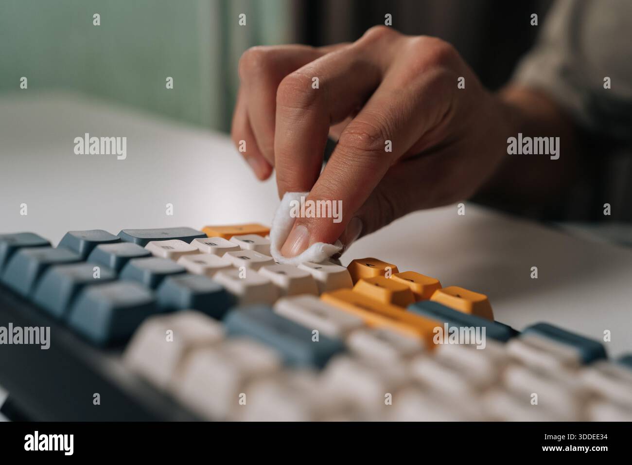 Computer Keyboard Hygiene Person cleaning and maintaining wireless mechanical keyboard, ensuring ...