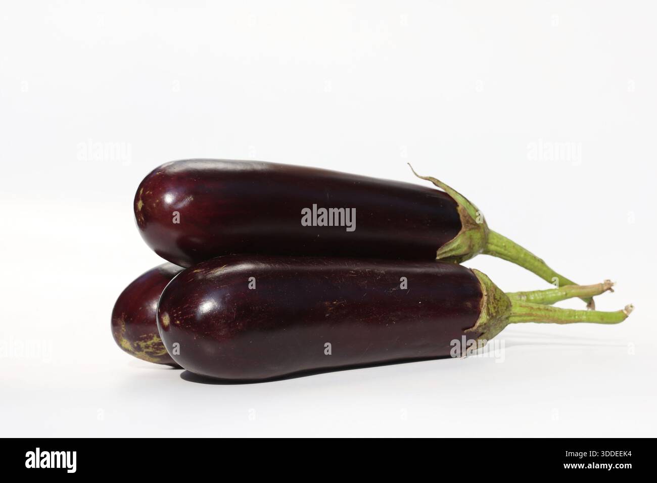 a stack of eggplants isolated on white background Stock Photo