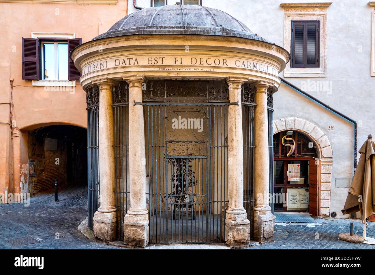 Tiny 18th-century chapel with dome and Doric columns in Piazza Costaguti — the Tempietto del Carmelo, Rome. Stock Photo