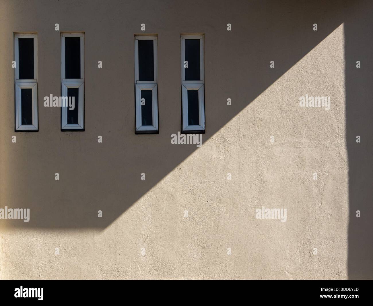 For aluminium rectangular glass window frame on a beige stone cement ...