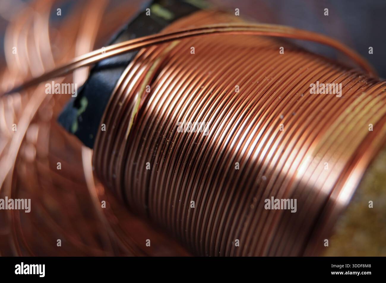 Copper wires wound on a spool. Copper in industry. Using copper material in technology. Stock Photo