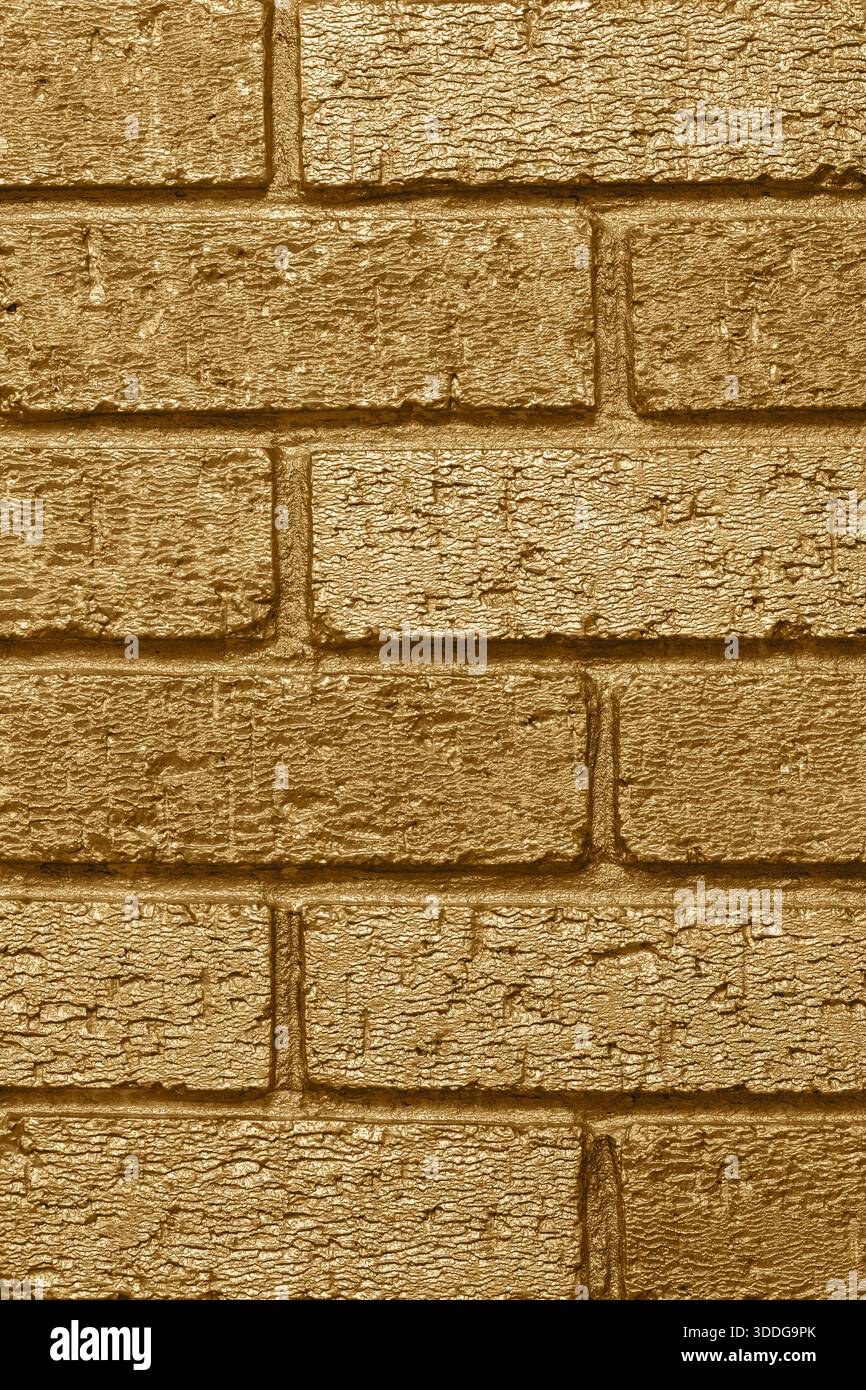 Brick wall background backdrop painted with metallic gold coloured paint. Interior design concept. Stock Photo