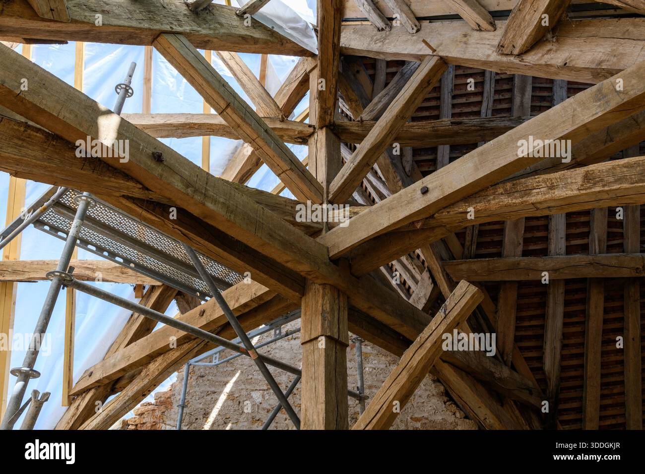 Detailed view of aged timber trusses and support beams in the roof ...
