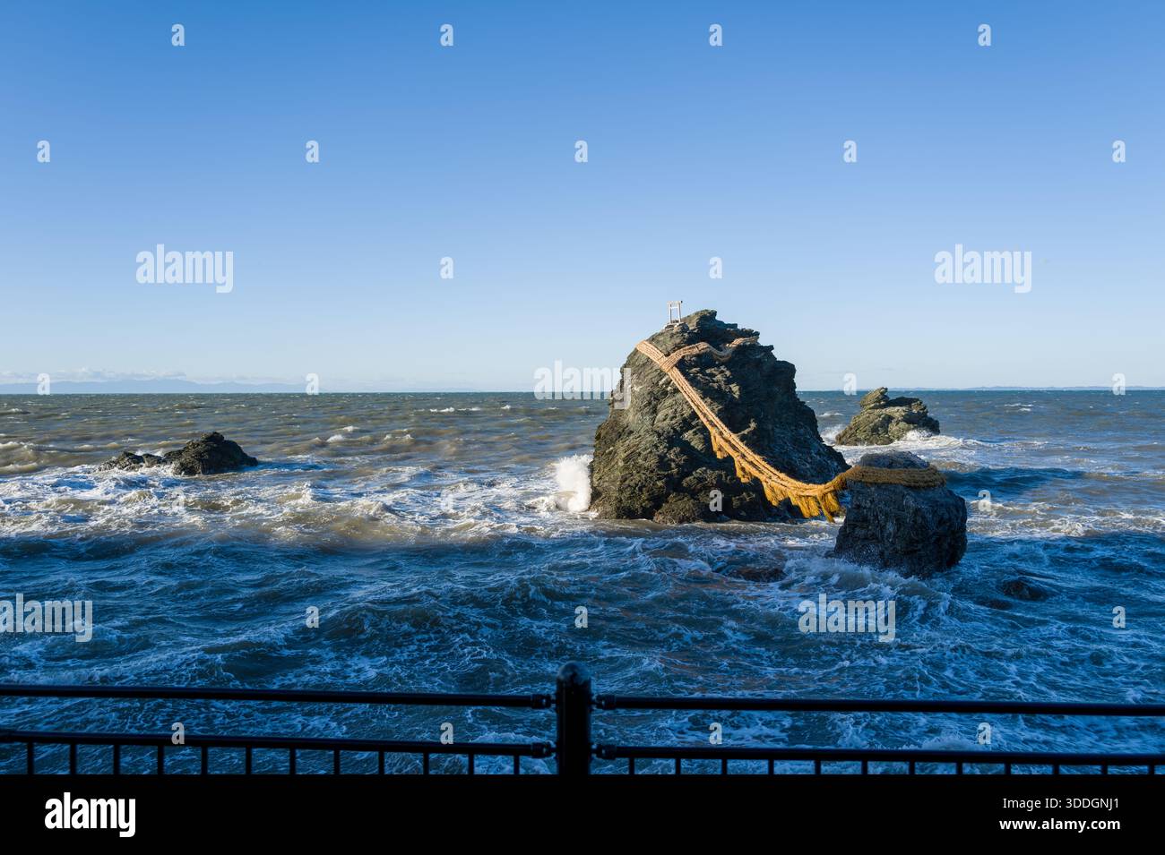 The iconic Meoto Iwa rocks, connected by a thick shimenawa rope, stand ...