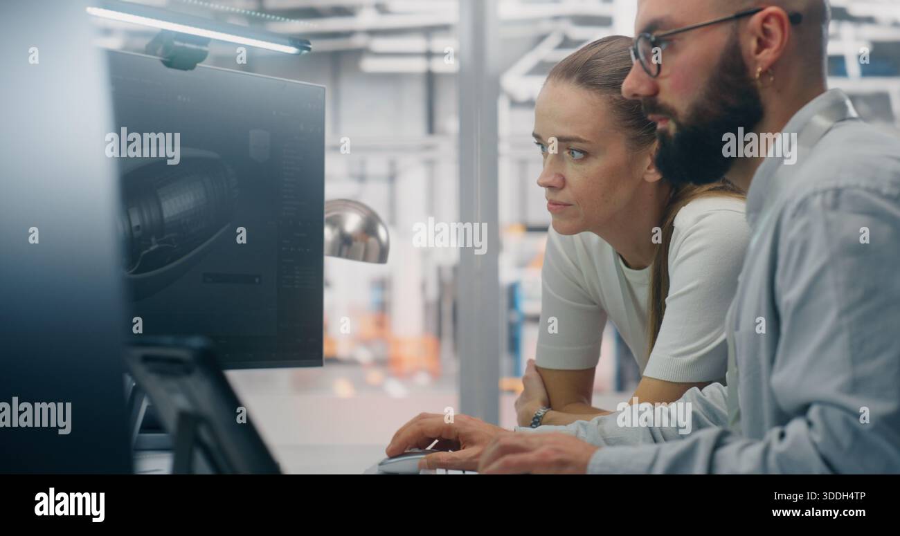 Specialists Discussing Manufacturing Specifications. Two Technical Specialists Deeply Engaged in Design Review, Examining Complex Technical Models on Computer Screen. Critical Problem Solving. Stock Photo