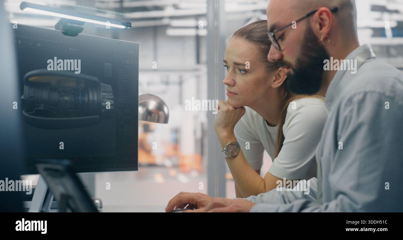 Specialists Discussing Manufacturing Specifications. Two Technical Specialists Deeply Engaged in Design Review, Examining Complex Technical Models on Computer Screen. Critical Problem Solving. Stock Photo