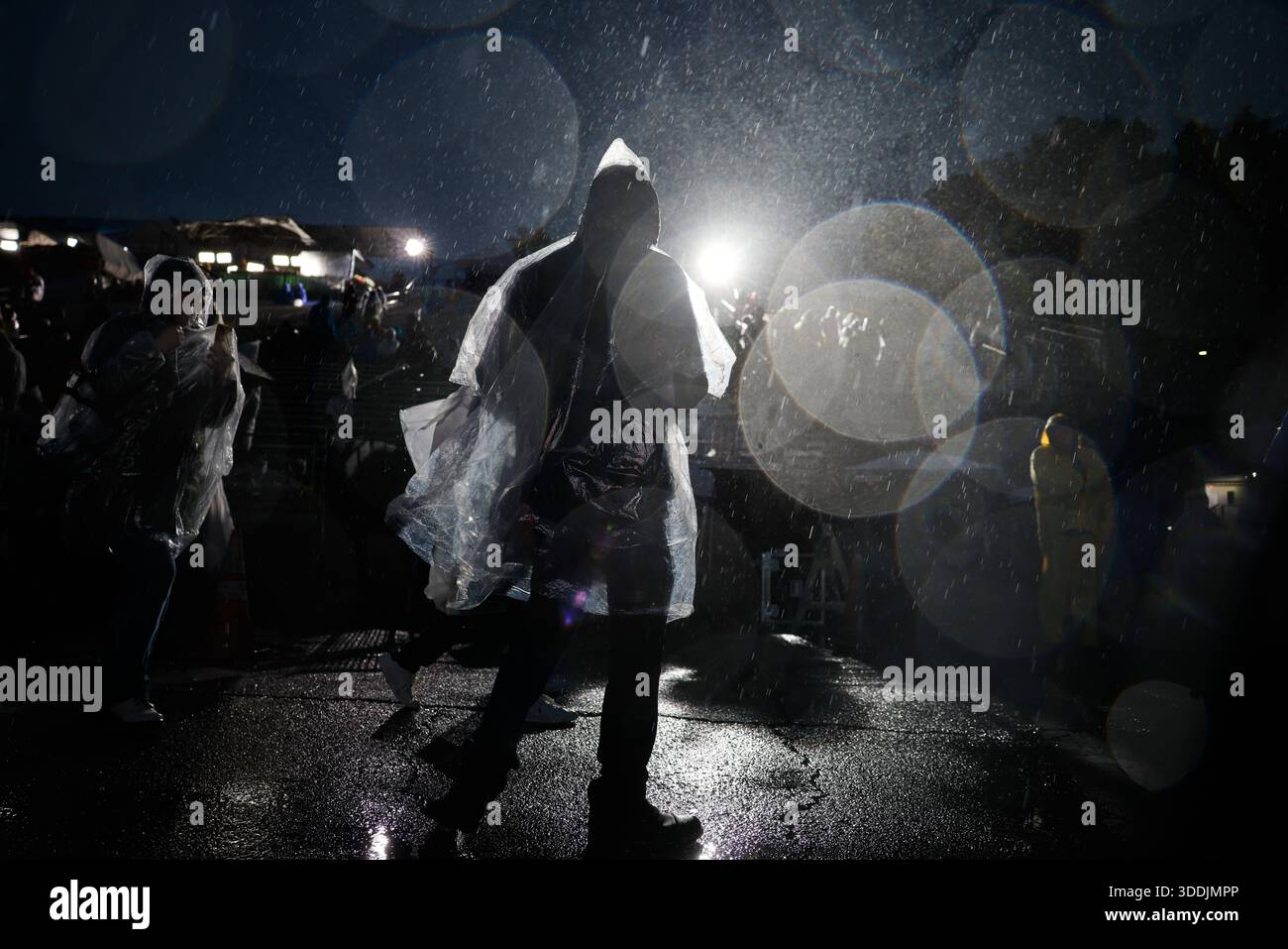 Rain comes down on attendees at the 137th Rose Parade Thursday, Jan. 1 ...