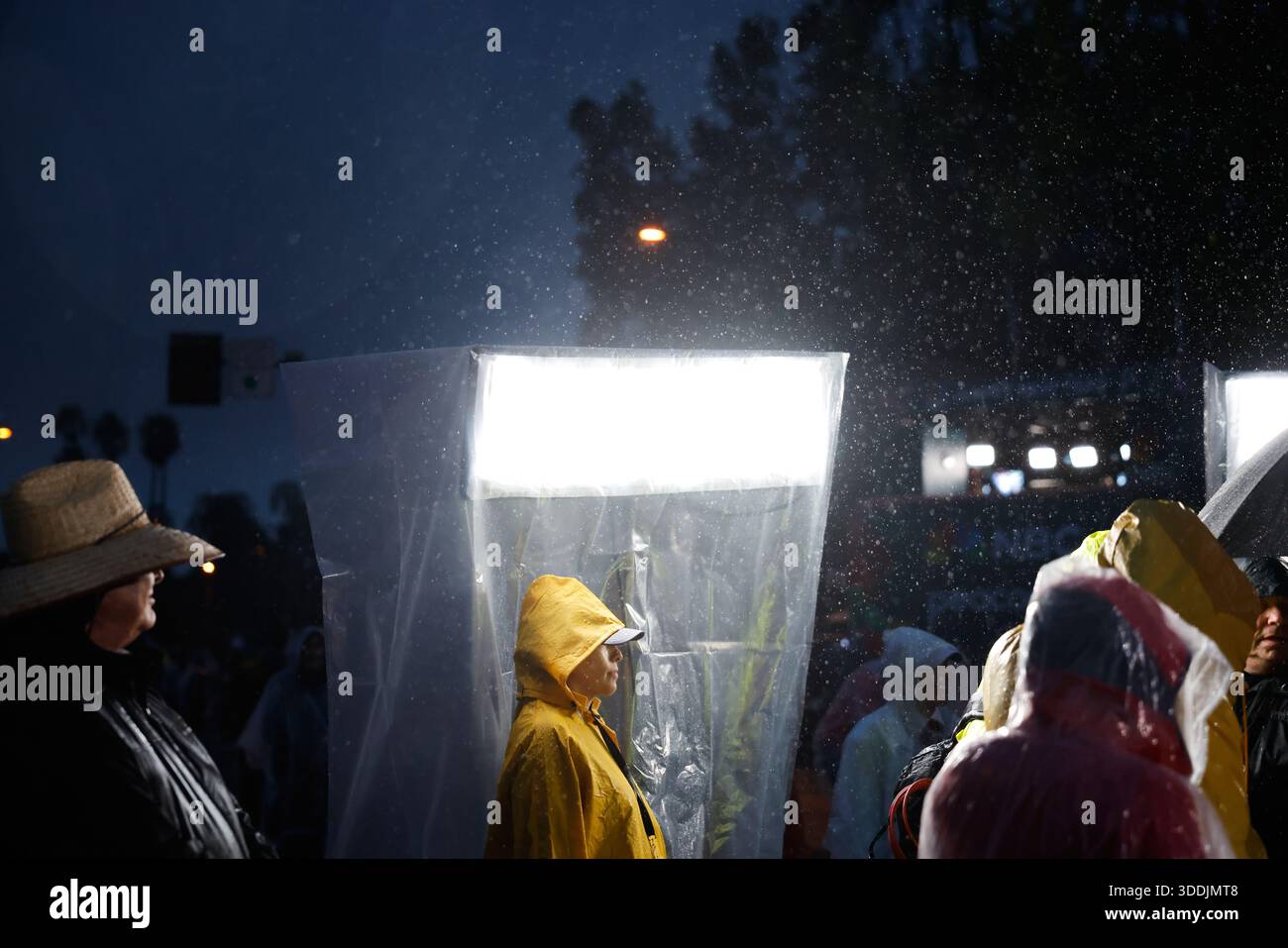 Rain comes down on attendees at the 137th Rose Parade Thursday, Jan. 1 ...