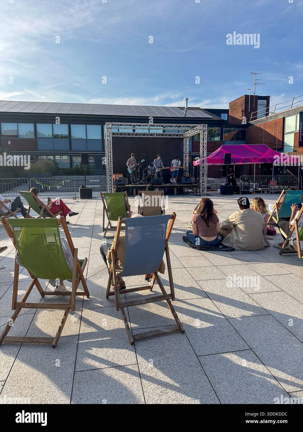 Live band performing in the Quad courtyard at University for the Creative Arts Farnham campus, Surrey, England, United Kingdom - Smartphone Captured Stock Image