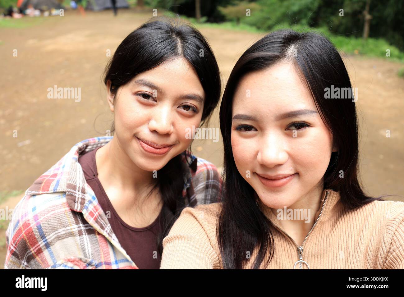 Two Young Beautiful Asian Woman Selfie at an Outdoor Camping Ground Stock Photo
