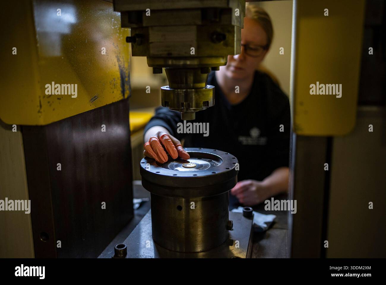 Royal Mint coin striking operator Judit Csontos lifts out a 200 Years ...