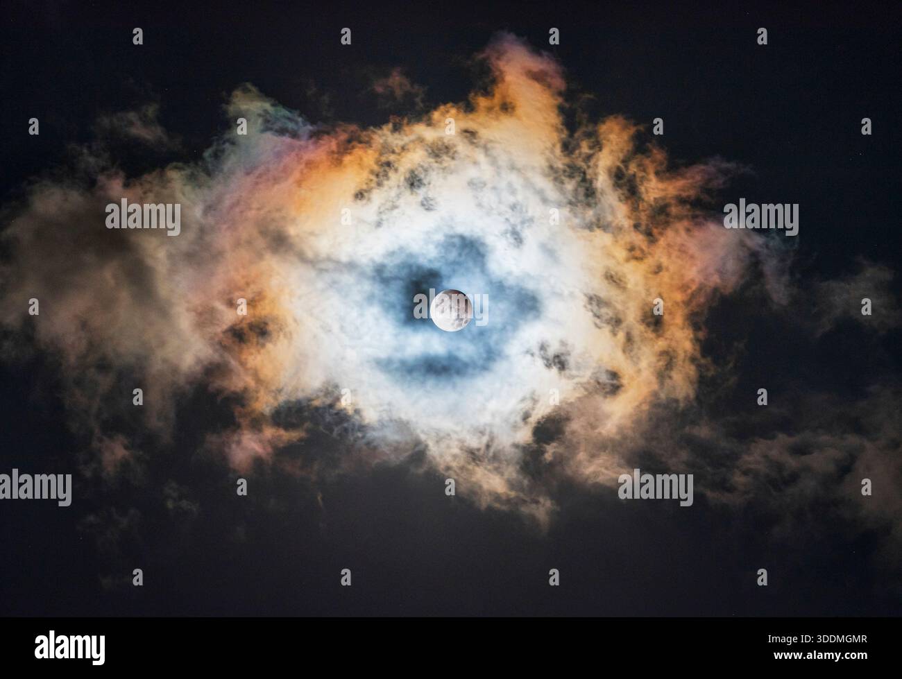 Partial Lunar Eclipse Over a Multicolored Cloudy Sky Stock Photo