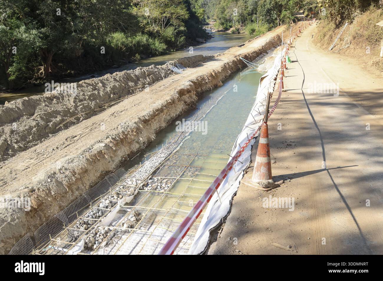 Unfinished road construction site with retaining wall structure and ...