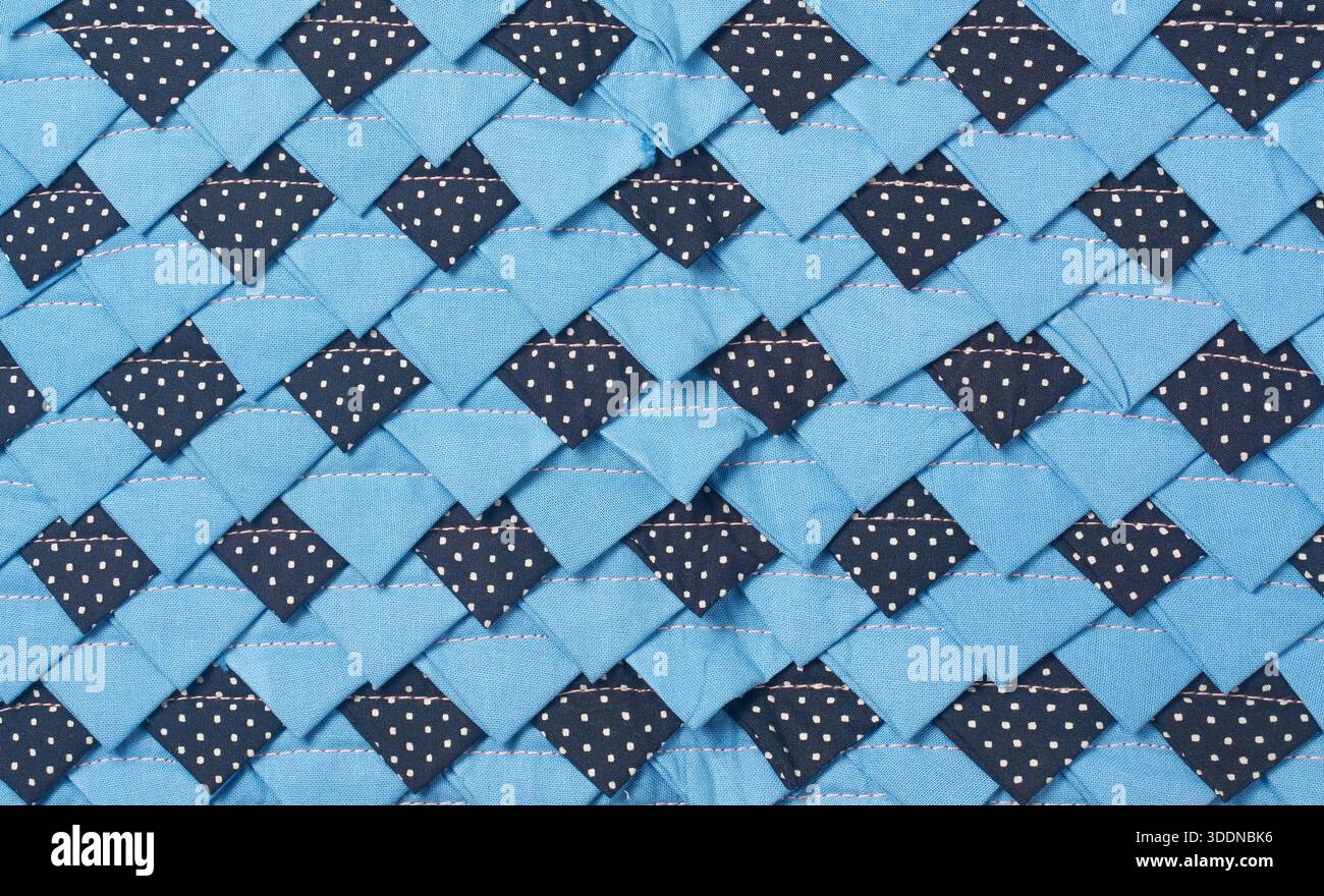 patchwork fabric mat textile surface, overlapping light and dark blue woven material texture, closeup full frame view, textile craft background Stock Photo